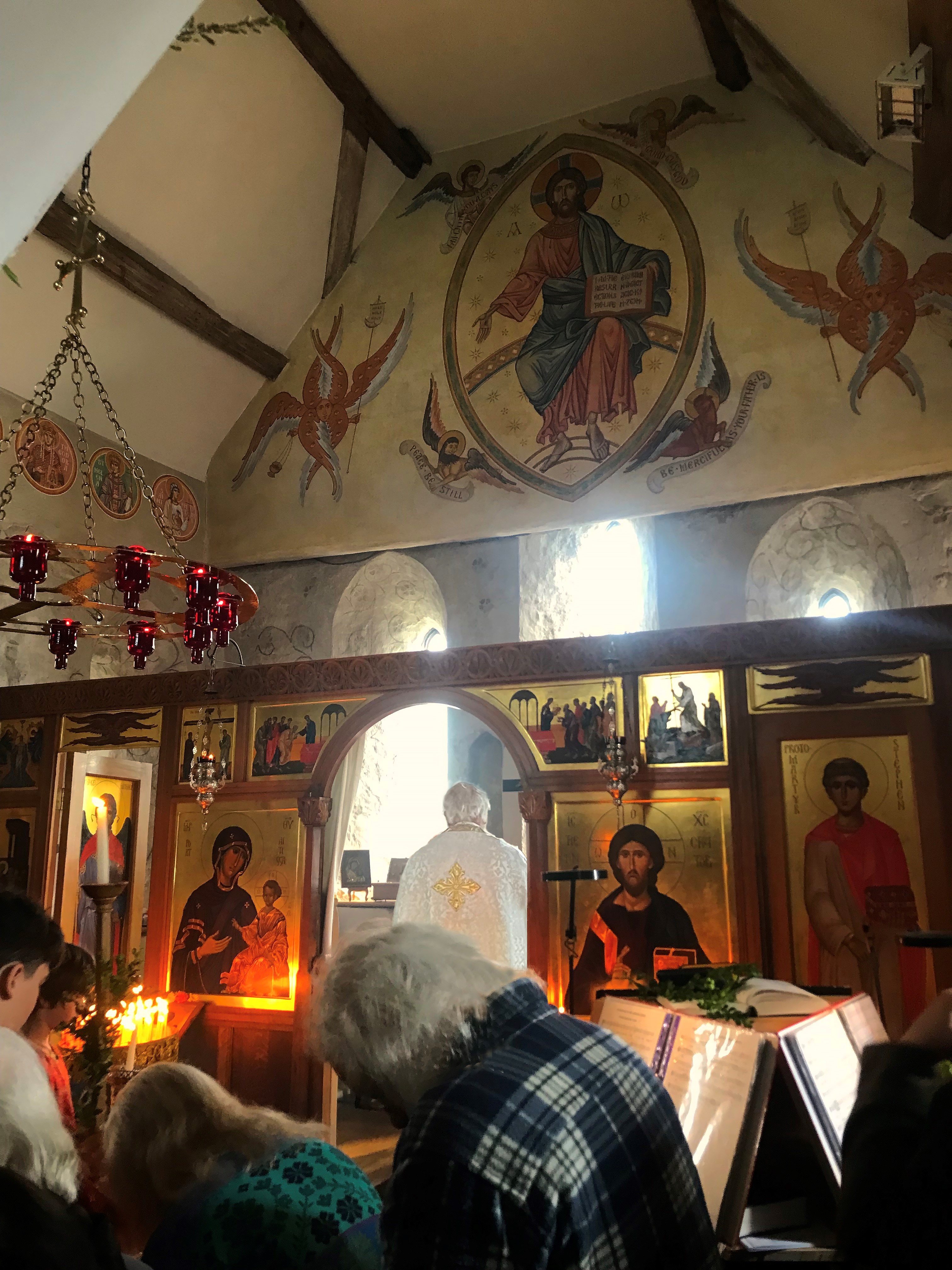 A church interior with icons displayed on the walls.